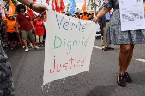 Demonstrators march with a placard &#x27; Truth, Dignity and Justice&#x27; during a rally in Saint-Denis de la Reunion on the French Indian island of La Reunion on January 19, 2023, as part of a strike by workers held to protest the French governments proposed pension reform to raise the legal retirement age from 62 to 64. - Sputnik International
