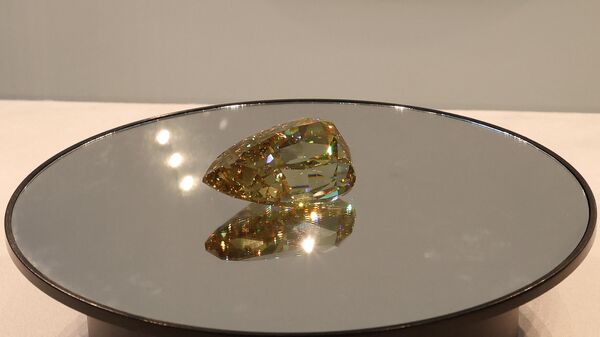 The Golden Canary brownish-yellow coloured diamond, weighing 303.10 carats, is displayed at Sotheby's in the Gulf emirate of Dubai on October 17, 2022.  - Sputnik International