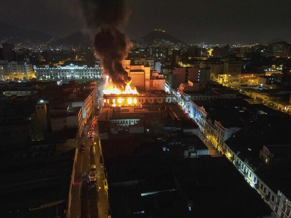 A building burns amid anti-government protests in downtown Lima, Peru, Thursday, January 19, 2023.  - Sputnik International