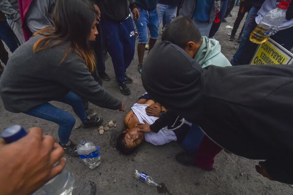 People aid a man injured during anti-government protests in Arequipa, Peru, Thursday, January 19, 2023. - Sputnik International