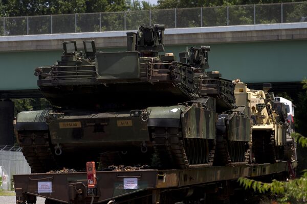 Abrams tanks are seen on a flat car in a rail yard, Tuesday, July 2, 2019. - Sputnik International