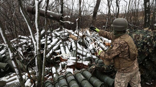 A Ukrainian artilleryman throws an empty 155MM shell tube as Ukrainian soldiers fire a M777 howitzer towards Russian positions on the frontline of eastern Ukraine, on November 23, 2022. - Sputnik International