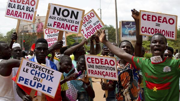 Supporters of Capt. Ibrahim Traore protest against France and the West African regional bloc known as ECOWAS in the streets of Ouagadougou, Burkina Faso, Tuesday, Oct. 4, 2022. - Sputnik International