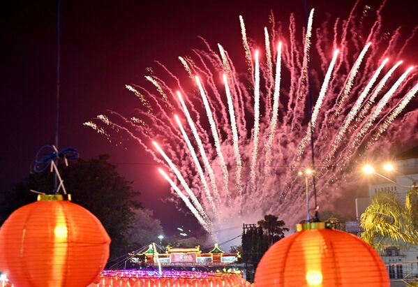 Fireworks explode over lanterns to celebrate the lunar new year in Solo, Central Java on 22 January 2023. - Sputnik International