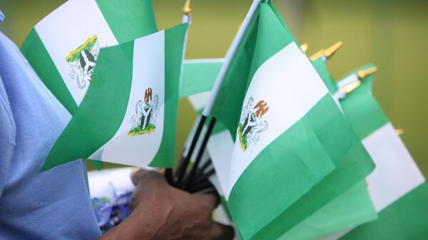 An unidentified woman sells Nigerian national flags, during an event to mark Nigeria independence day, in Lagos, Nigeria. Tuesday, Oct. 1, 2013 - Sputnik International
