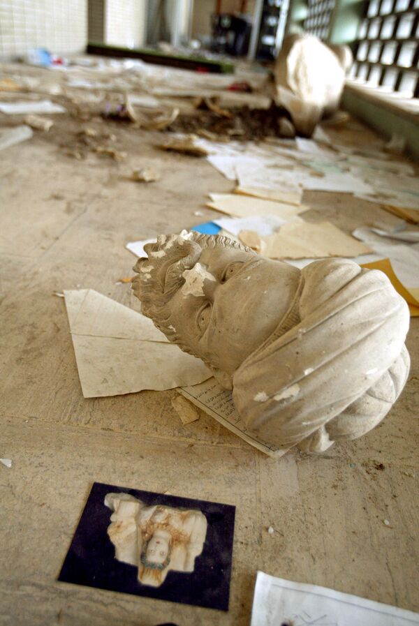 Parts of a beheaded sculpture lie among rubble after a mob of looters ransacked and looted Iraq&#x27;s largest archeological museum in Baghdad, April 13, 2003. The pillaging of the Iraqi National Museum in the immediate aftermath of Baghdad&#x27;s fall in April 2003 shocked the world, but while many of those antiquities have since been recovered, the looting has taken off in the archaeological sites scattered around the perilous countryside. AFP PHOTO PATRICK BAZ (Photo by PATRICK BAZ / AFP) - Sputnik International