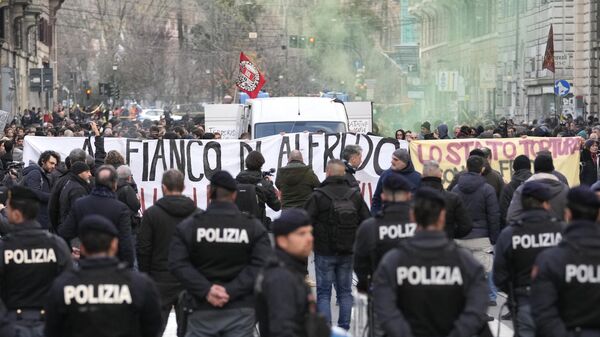 Demonstrators show banners reading By Alfredo side and the The state tortures Alfredo during a protest in solidarity with Alfredo Cospito, the jailed anarchists leader in hunger strike for more than 100 days, in Rome, Saturday, Feb. 4, 2023. - Sputnik International