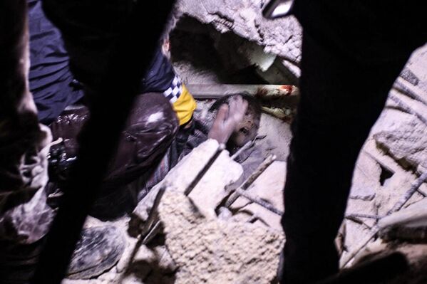 Rescuers try to free a young boy from the rubble of a collapsed building  following an earthquake, in the Syrian border town of Azaz on February 6, 2023. (Photo by Nayef Al-ABOUD / AFP) - Sputnik International