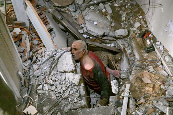 A man trapped in the rubble waits while debris is removed to work on his rescue in Hatay on 7 February 2023, a day after a 7.8-magnitude earthquake struck the country&#x27;s south-east. - Sputnik International