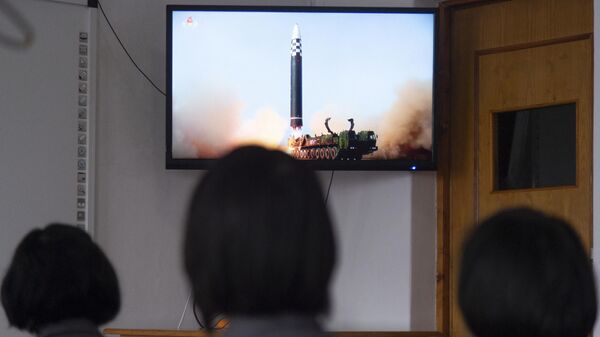 In this photo taken in Pyongyang on March 25, 2022, students of the Pyongyang Jang Chol Gu University of Commerce watch footage of the previous day's launch of the Hwasong-17 missile - Pyongyang's first ICBM test since 2017 - Sputnik International