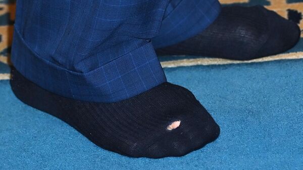 The socks of Britain's King Charles III are pictured during his visit Brick Lane Mosque during a visit to Brick Lane in east London on February 8, 2023. - Sputnik International