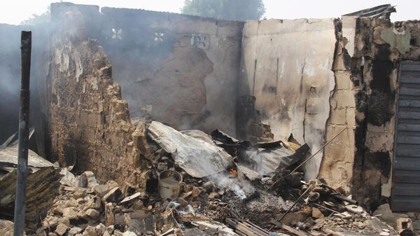 In this photograph taken in Auno on February 10, 2020, shops burnt down by suspected members of the Islamic State West Africa Province (ISWAP) during an attack on February 9, 2020, is seen. - Jihadists killed at least 30 people and abducted women and children in a raid in northeast Nigeria's restive Borno state, a regional government spokesman said on February 10, 2020. - Sputnik International