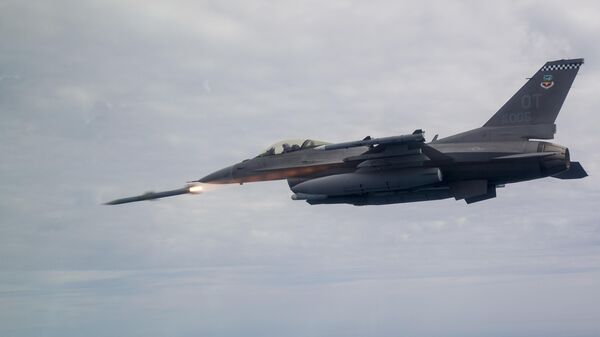An F-16C Fighting Falcon assigned to the 85th Test Evaluation Squadron shoots an AIM-120 Advanced Medium-Range Air-to-Air Missile, or AMRAAM over testing ranges near Eglin Air Force Base, Fla., March 19, 2019. - Sputnik International
