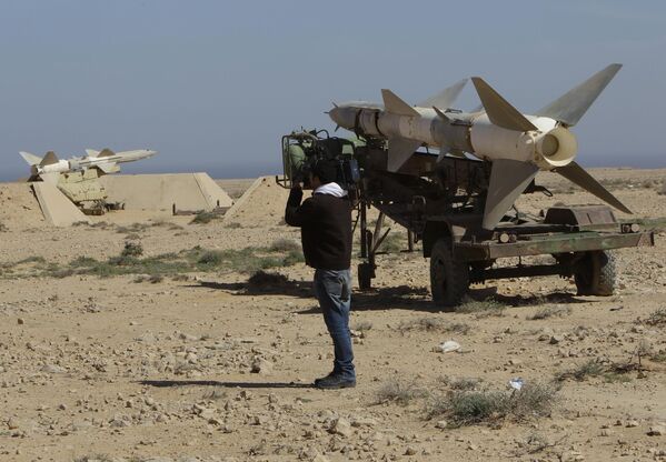 A cameraman records anti-aircraft missiles at an abandoned Libyan military base near Tobruk, Libya, on Wednesday 23 February 2011.   - Sputnik International