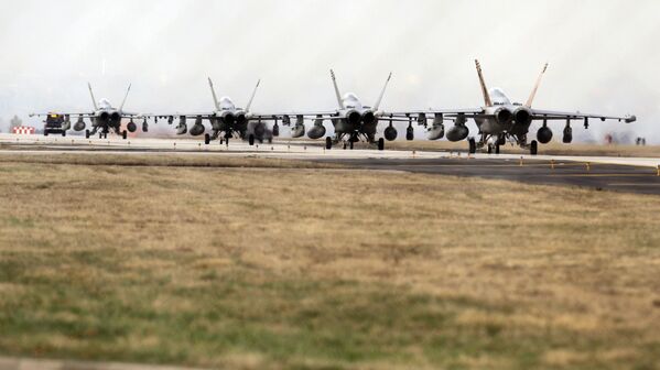 F-18 growler jet fighters seen through a fence are parked at the Nato airbase in Aviano, Italy on Saturday 19 March 2011. At this point, NATO&#x27;s top decision-making body was meeting to review military plans for a no-fly zone over Libya. - Sputnik International