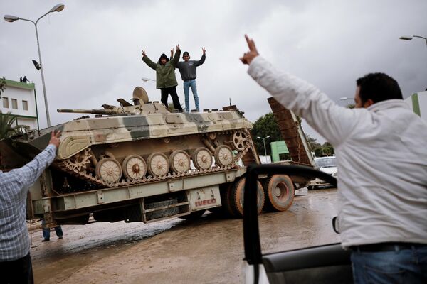 Residents of Benghazi remove armored vehicles abandoned by the military. - Sputnik International