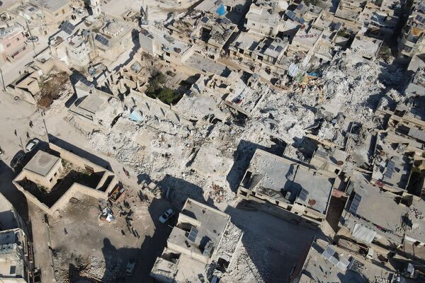 An aerial view shows collapsed buildings after last week&#x27;s earthquake in Syria&#x27;s rebel-held village of Atarib, in the north-western Aleppo province, on 14 February 2023. - Sputnik International