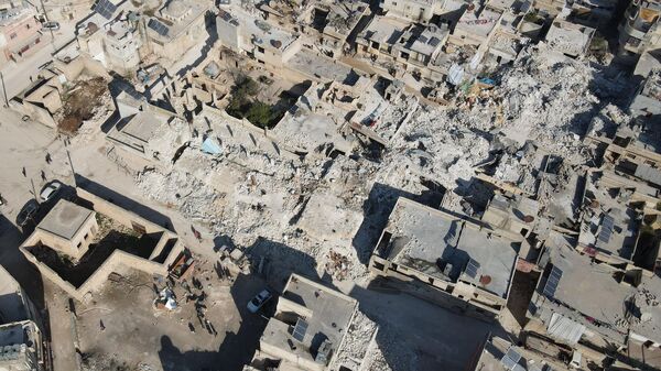 An aerial view shows collapsed buildings following last week's earthquake in Syria's rebel-held village of Atarib, in the northwestern Aleppo province, on February 14, 2023. - Sputnik International