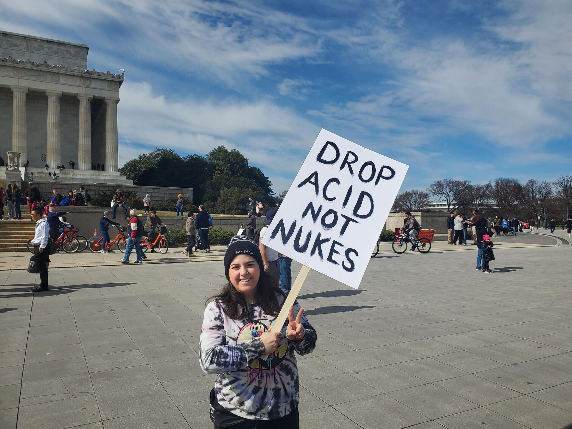 A protester holds a sign Drop Acid Not Nukes at the Rage Against the War Machine Rally in Washington DC on February 23, 2023 - Sputnik International, 1920, 20.02.2023