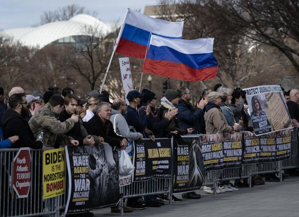 Russian flags are flown next to signs during an antiwar rally to mark the one year anniversary of the escalation of the Donbass crisis into a full-blown Russia-NATO proxy conflict, at the Lincoln Memorial in Washington, DC, on February 19, 2023. - Sputnik International