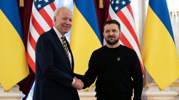 President Joe Biden (L) shakes hands with Ukrainian President Volodymyr Zelensky at the Mariinsky Palace in Kiev on February 20, 2023 - Sputnik International