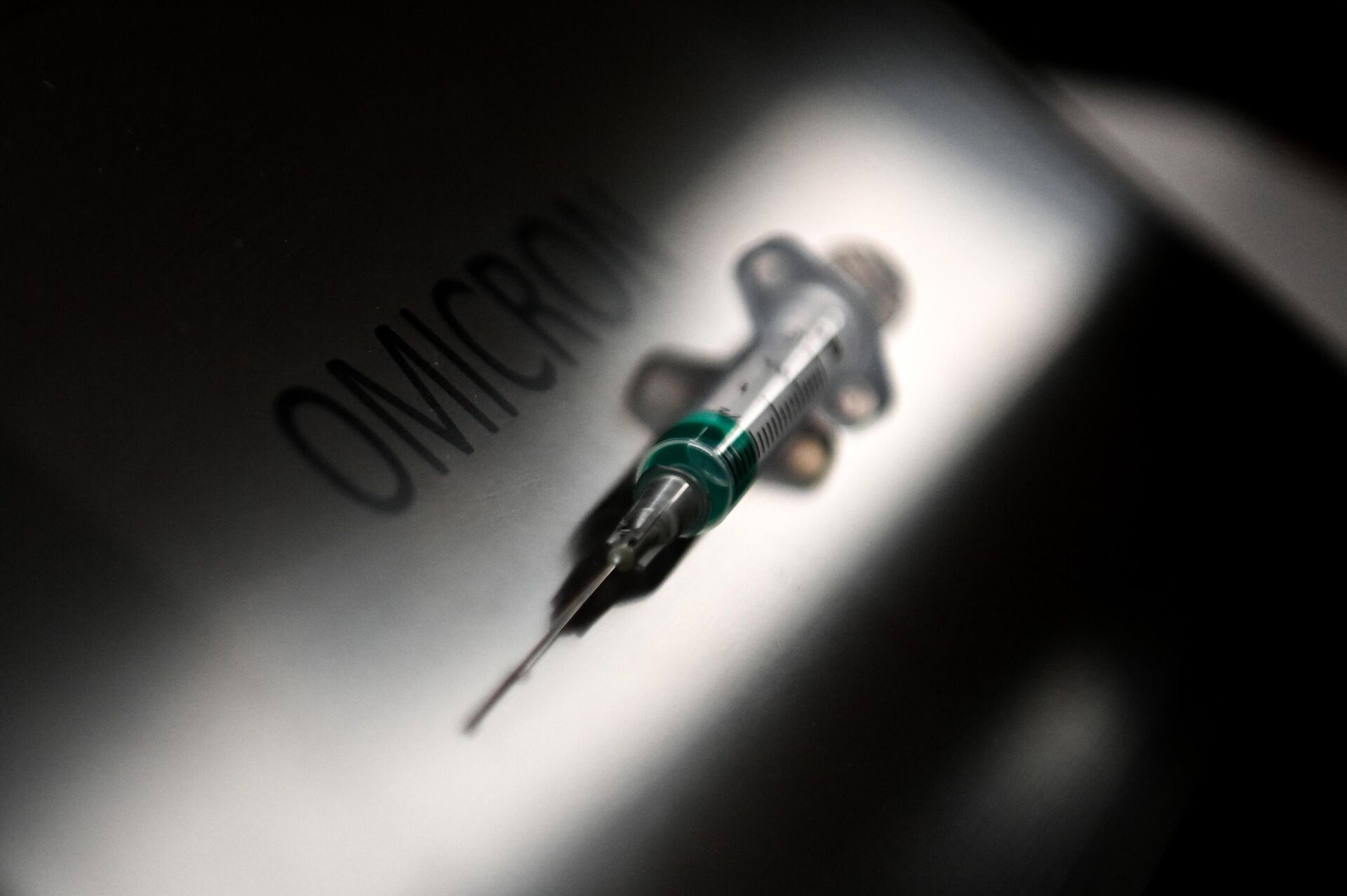 An illustration picture taken on January 19, 2022, shows a syringe next to the word Omicron. - Sputnik International, 1920, 21.02.2023