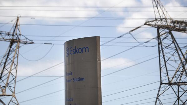 A sign for Eskom, the South African electricity authority, stands next to electricity pylons near Cape Town on January 22, 2023.  - Sputnik International
