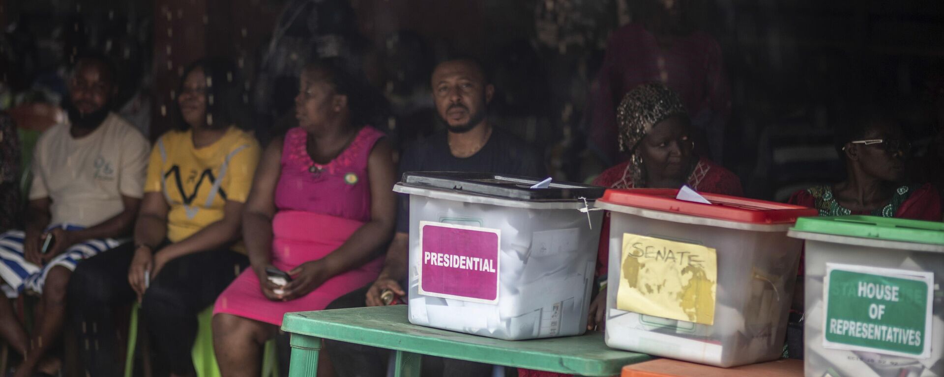 People sit in line next to the ballot boxes displayed on the tables, as they wait to cast their votes at a polling station during the presidential elections in Agulu, Nigeria, Saturday, Feb. 25, 2023.  - Sputnik International, 1920, 26.02.2023