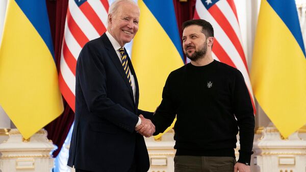President Joe Biden (L) shakes hands with Ukrainian President Volodymyr Zelensky at the Mariinsky Palace in Kyiv on February 20, 2023. - Sputnik International