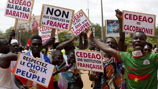 Supporters of Capt. Ibrahim Traore protest against France and the West African regional bloc known as ECOWAS in the streets of Ouagadougou, Burkina Faso, Tuesday, Oct. 4, 2022 - Sputnik International