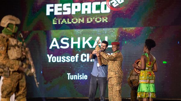 A man (2nd L) representing the Tunisian director Youssef Chebbi, receives from Burkina Faso military leader Captain Ibrahim Traore (3rd L) the Etalon d'Or won for the film Ashkal, during the closing ceremony of the 28th Pan-African Film and television Festival (FESPACO), in Ouagadougou, on March 4, 2023 - Sputnik International