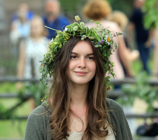 A young woman takes part in a traditional mid-summer solstice celebration (Rasos Festival) at the Open-Air Museum of Lithuania in Rumsiskes, east of Kaunas. - Sputnik International