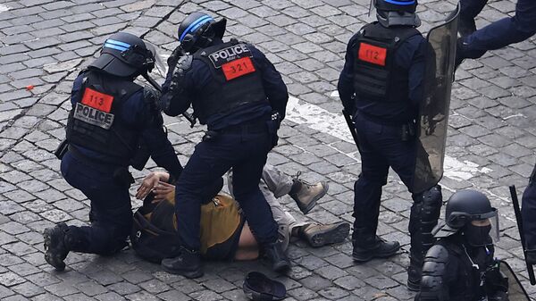 A protester is detained by riot police officers during a demonstration, Tuesday, March 7, 2023 in Paris. - Sputnik International
