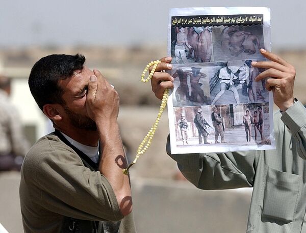 A relation of an Iraqi prisoner of war cries after being shown a report about the atrocities in Abu Ghraib. - Sputnik International