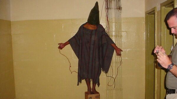 This is an image obtained by The Associated Press which shows an unidentified detainee standing on a box with a bag on his head and wires attatched to him in late 2003 at the Abu Ghraib prison in Baghdad, Iraq - Sputnik International