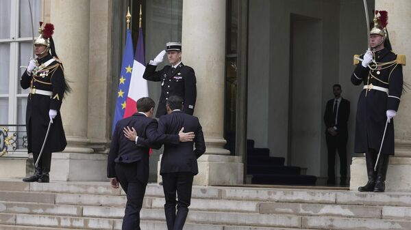 Britain's Prime Minister Rishi Sunak, center right, and French President Emmanuel Macron walk during their meeting at the Elysee Palace in Paris - Sputnik International