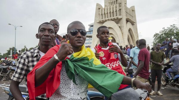 A man wears a national flag as he celebrates with others in the streets in the capital Bamako, Mali Tuesday, Aug. 18, 2020 - Sputnik International