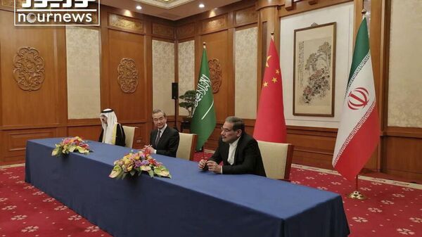 In this photo released by Nournews, Secretary of Iran's Supreme National Security Council, Ali Shamkhani, right, China's most senior diplomat Wang Yi, center, and Saudi Arabia's National Security Adviser Musaad bin Mohammed al-Aiban looks on during an agreement signing ceremony between Iran and Saudi Arabia to reestablish diplomatic relations and reopen embassies after seven years of tensions between the Mideast rivals, in Beijing, China, Friday, March 10, 2023. - Sputnik International