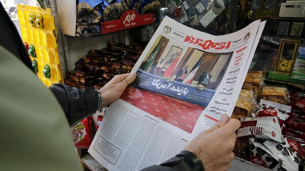 A woman in Tehran holds a local newspaper reporting on its front page the China-brokered deal between Iran and Saudi Arabia to restore ties, signed in Beijing the previous day, on March, 11 2023. - Sputnik International