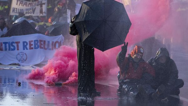 Police used a water cannon during a climate protest when activists blocked a major highway in The Hague, Netherlands, Saturday, March 11, 2023.  - Sputnik International