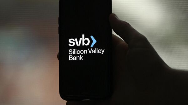This illustration picture shows the Silicon Valley Bank (SVB) logo displayed on a smartphone in Arlington, Virginia, on March 10, 2023 - Sputnik International
