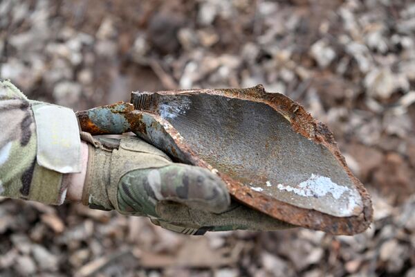 In some instances, Ukrainian militants even used munitions filled with phosphorus. Above: A Wagner fighter holds a Ukrainian shell fragment in DPR.  - Sputnik International