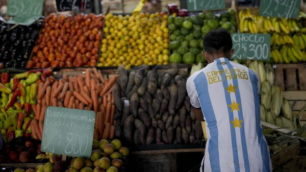 A worker wearing an Argentine soccer jersey that says in Spanish World Champions, referring to Argentina's 2022 World Cup title, arranges vegetables at the central market in Buenos Aires, Argentina, Monday, Feb. 13, 2023. On Feb. 14, the government statistics service (INDEC) will release January's Consumer Price Index for Argentina, which has one of the world's highest inflation rates. - Sputnik International