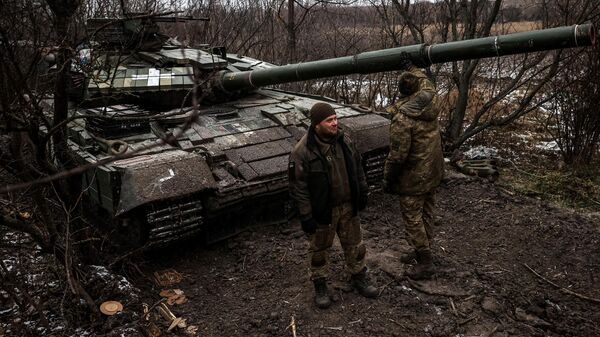 Ukrainian servicemen stand near a tank on the frontline near Kreminna, Lugansk region, on January 12, 2023 - Sputnik International