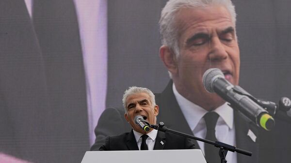 Israel's opposition leader and former Prime Minister Yair Lapid speaks during a rally against plans by Prime Minister Benjamin Netanyahu's new government to overhaul the judicial system, outside the Knesset, Israel's parliament, in Jerusalem, Monday, Feb. 13, 2023. - Sputnik International