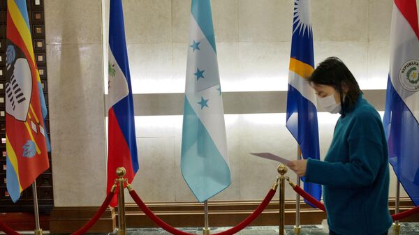A woman walks past a Honduras flag (C) at Taiwan’s Ministry of Foreign Affairs in Taipei on March 15, 2023.  - Sputnik International