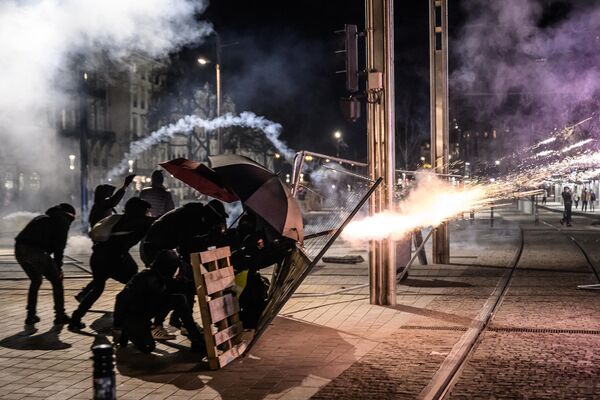 Demonstrators clash with riot police during a demonstration after the French government pushed pensions reform through parliament without a vote, using Article 49.3 of the constitution, in Nantes, western France, on 16 March 2023. - Sputnik International