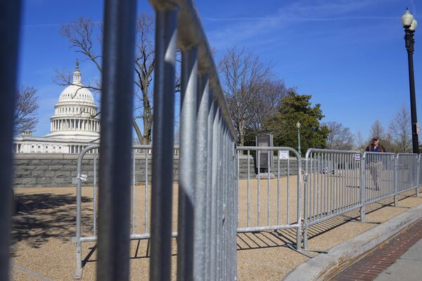The United States Capitol Police has also elevated security preparations for protests that may take place in Washington ahead of a possible indictment of the ex-POTUS.Above: Security fencing placed around the US Capitol. - Sputnik International