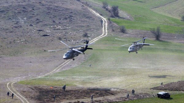 U.S Army helicopters take off after deploying U.S soldiers serving in the NATO-led peacekeeping mission in Kosovo to guard a Serb Orthodox Church during a rapid deployment exercise in the eastern Kosovo village of Ropotovo on Thursday, March 15. 2007.  - Sputnik International