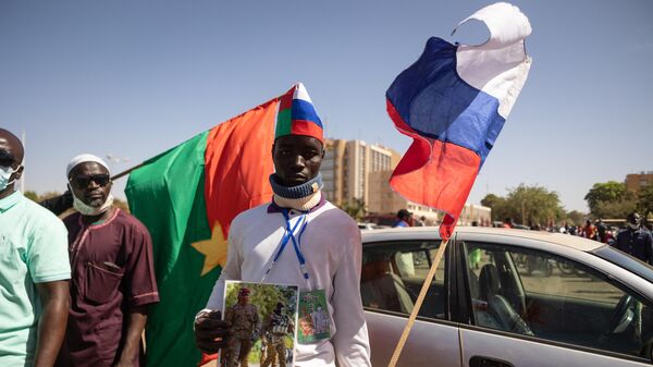 A man holds a Russian flag during a protest to support the Burkina Faso President Captain Ibrahim Traore and to demand the departure of France's ambassador and military forces, in Ouagadougou, on January 20, 2023 - Sputnik International